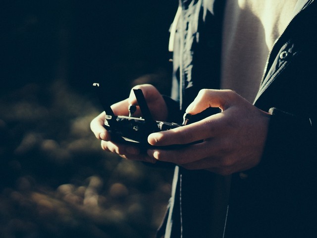 A person operating a drone by remote control